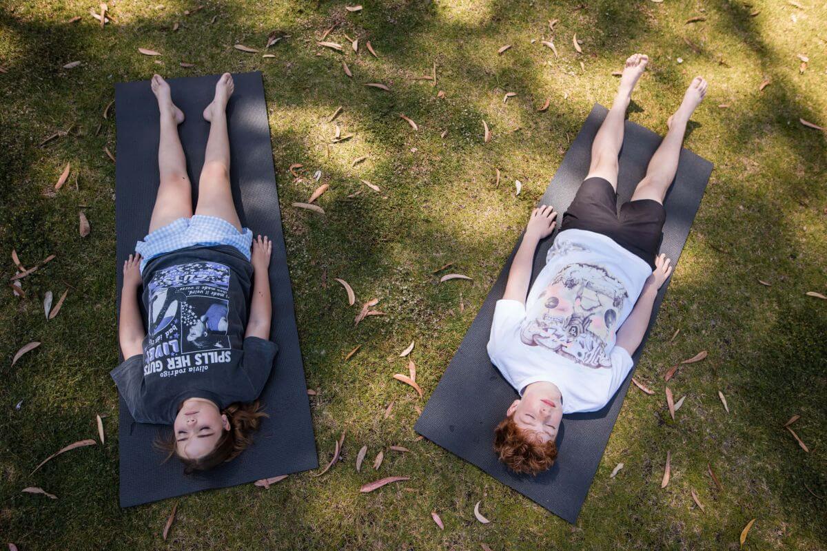 Teenagers relaxing in yoga