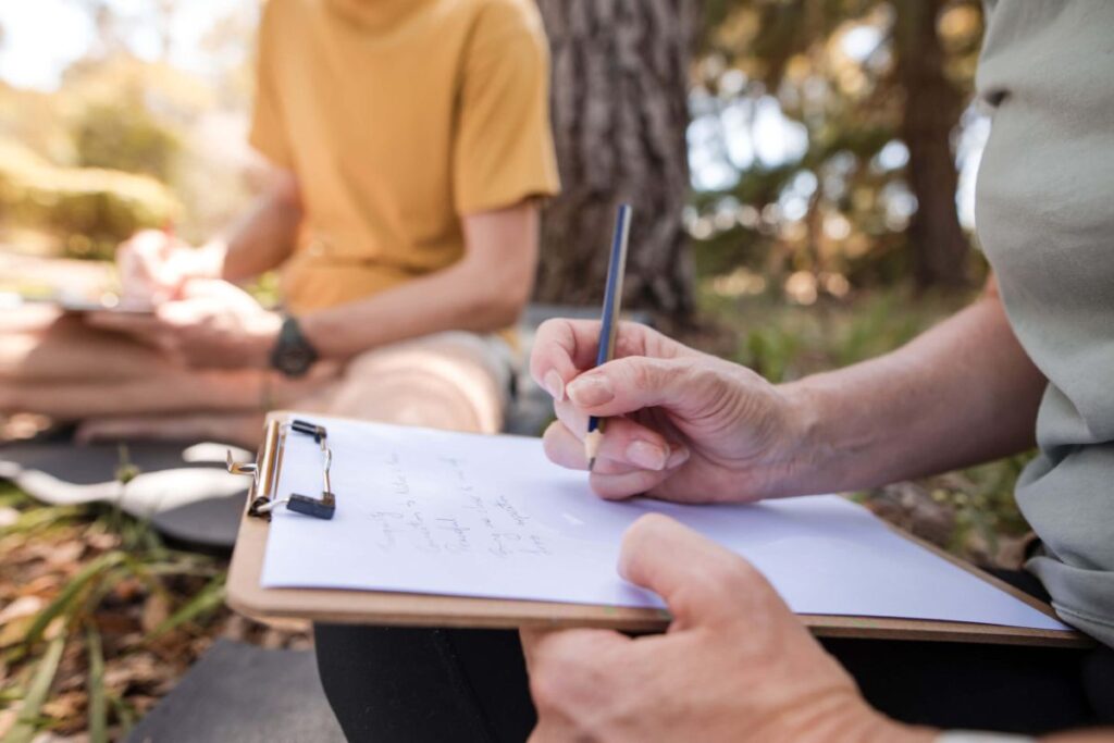 People mindfully journalling mural ideas