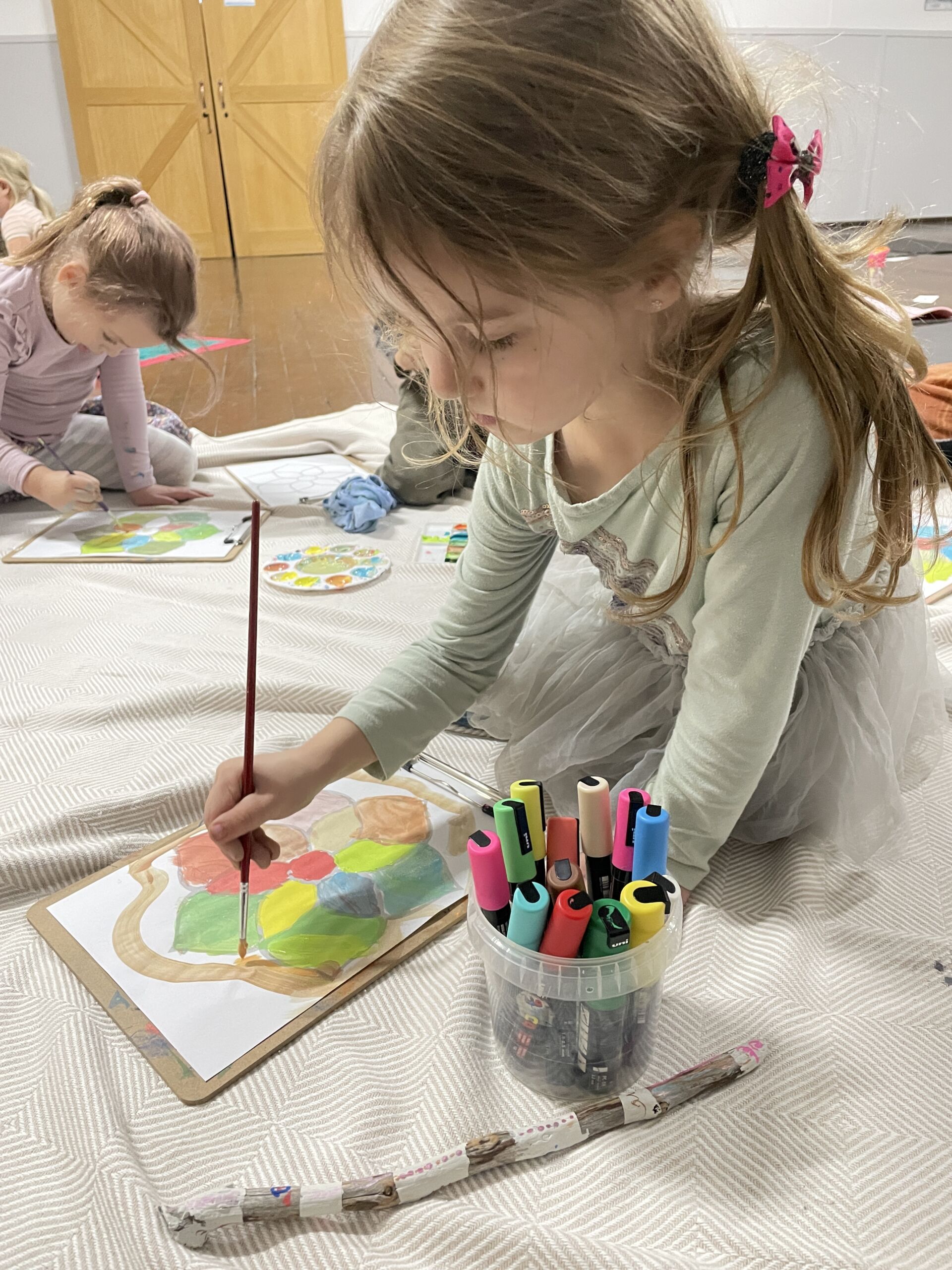 Young girl Painting a Mandala to Colour it in.